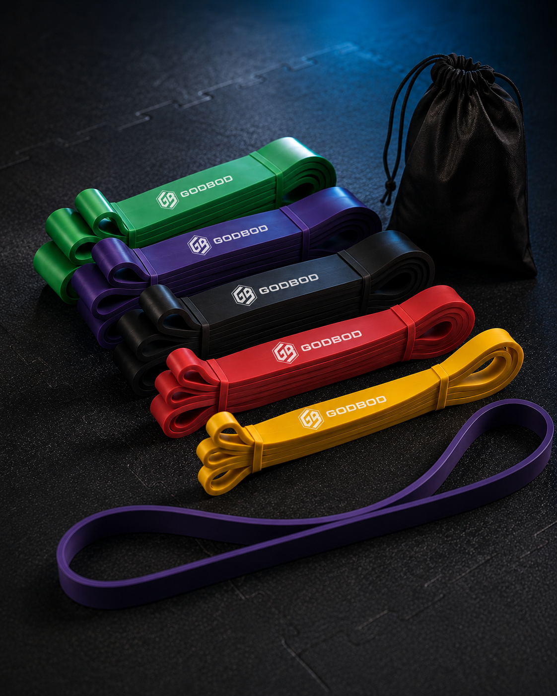 GODBOD long loop resistance bands and carry pouch on a dark training surface